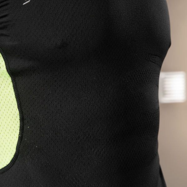 Close-up of the AEROFLEX performance top's breathable knit fabric, showing its texture and structure.