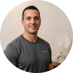 Circular portrait of Nathan Brooks, a fit man, smiling confidently in a charcoal grey AEROFLEX quick-dry top against a cream 